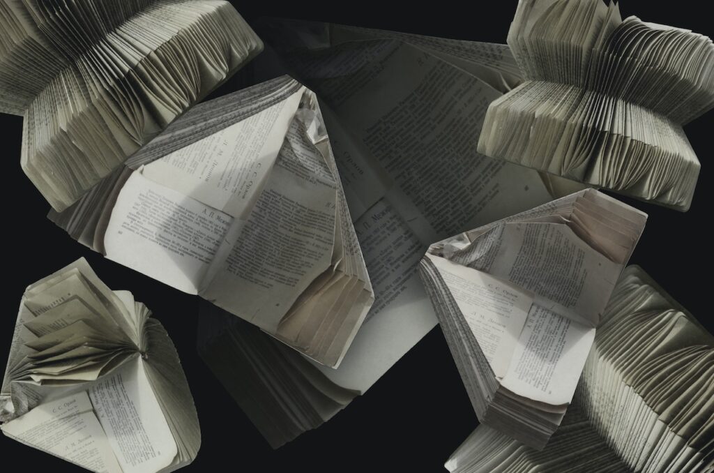 Fotografia przedstawia poskładane z gazet samolociki. Jest to ilustracja do bloga o tytule: "Recykling makulatury - papieru - ja?".